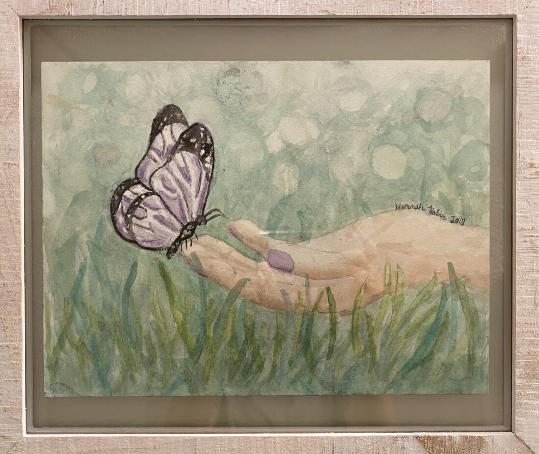 A hand with purple nail polish holds a purple butterfly in a painting, symbolizing creativity in K-12 online learning.