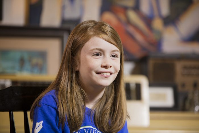 A young girl smiling for the camera.