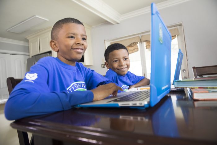 Two young boys in front of a laptop.
