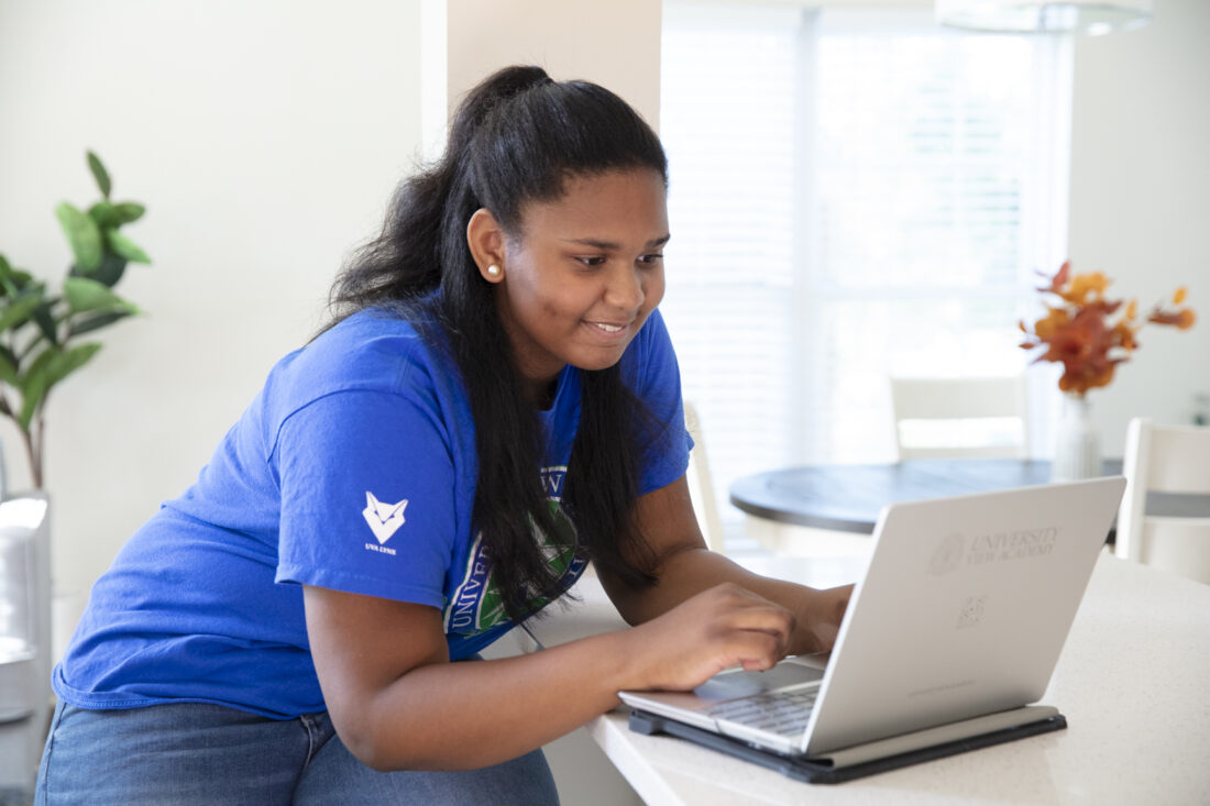 A high school student at her computer.