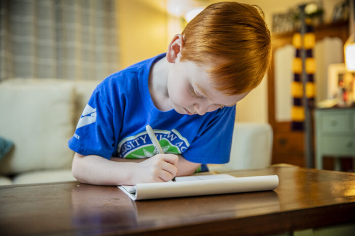 A young boy working on his schoolwork.