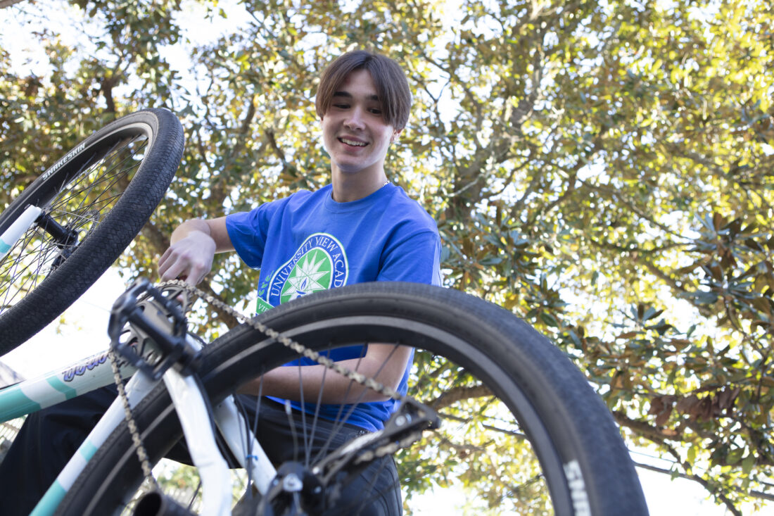A technical college student, working on a bike.