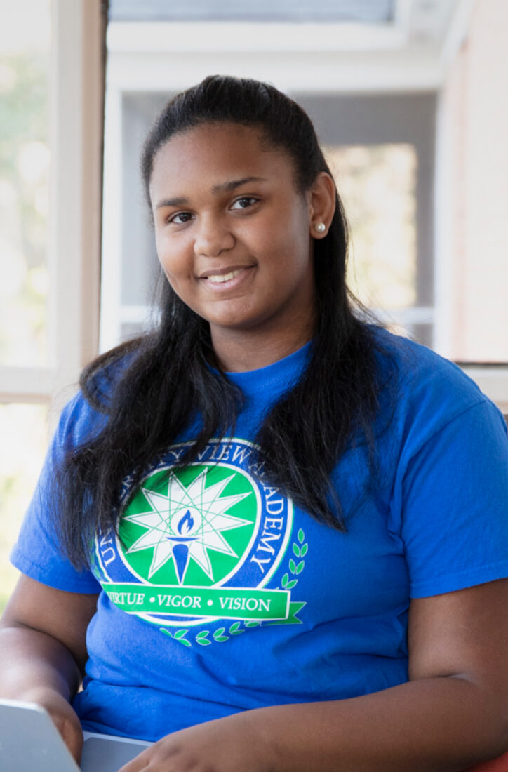 Portrait photograph of a smiling teenage girl.