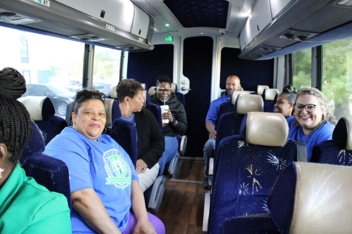 Photo of a bus full of teachers traveling to Open House.