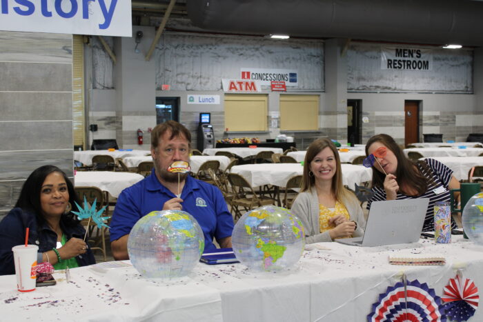 A group of people with props posing for the camera.