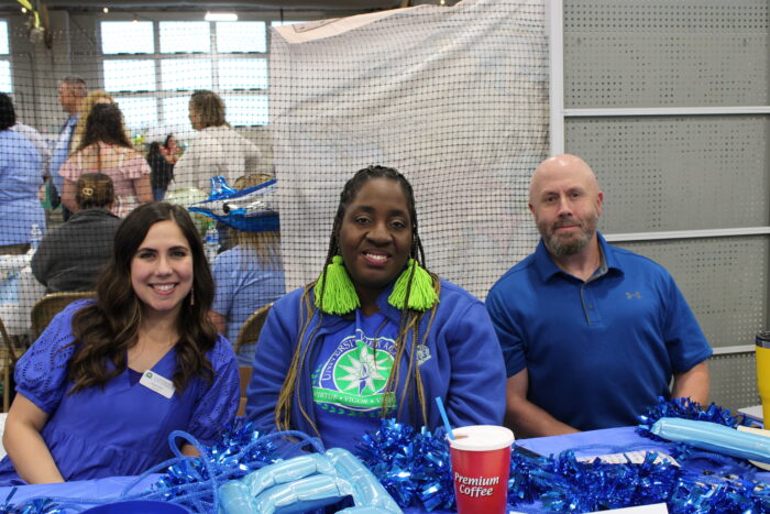 Three smiling teachers posing for the camera.