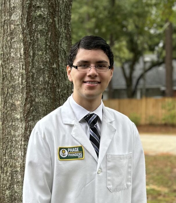 Headshot of a young man in a lab coat