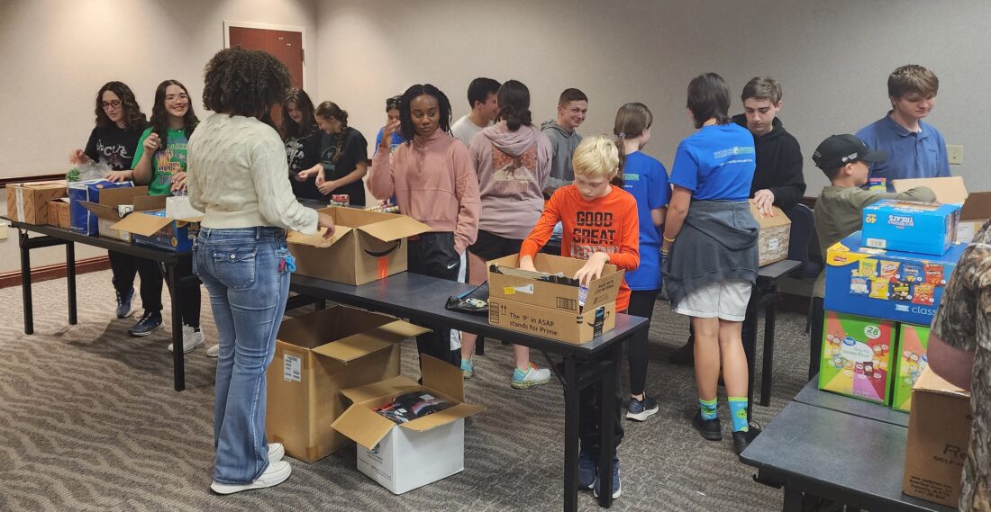 Members of UVA's NHS, DECA, and Beta clubs assemble care packages for troops overseas during the holidays