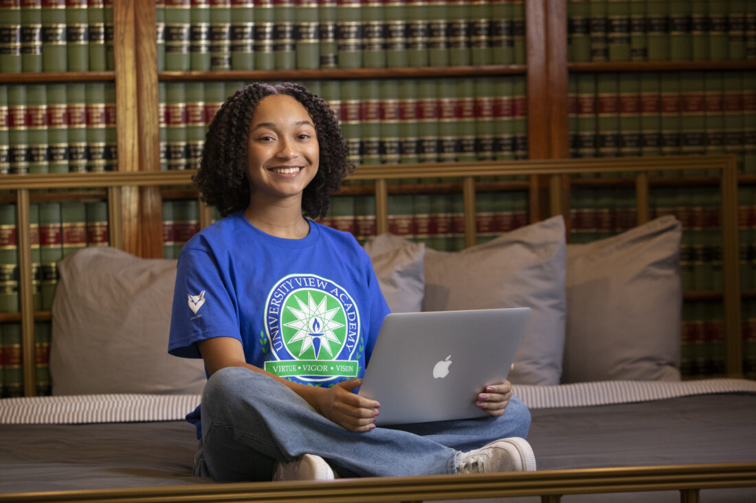 High School senior girl attends live lessons online.