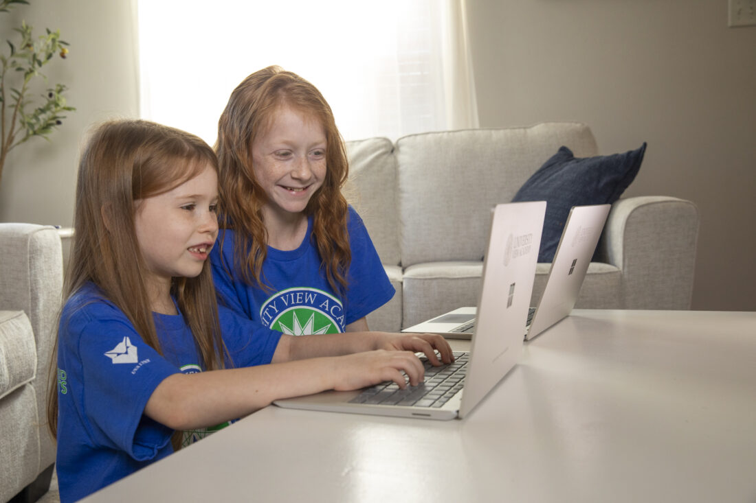 Two sisters learn online at University View Academy.