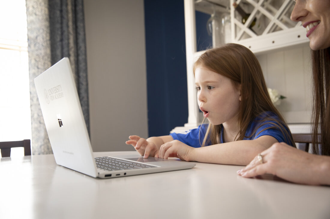 Elementary school kid excited for online learning.