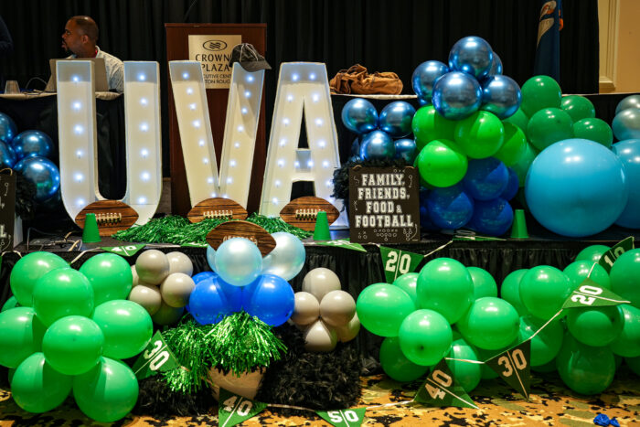 A UVA centerpiece with blue and green balloons decorates staff convocation.