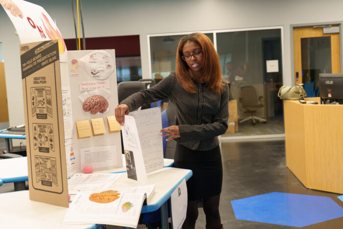 A UVA high schooler presents her project at the science fair