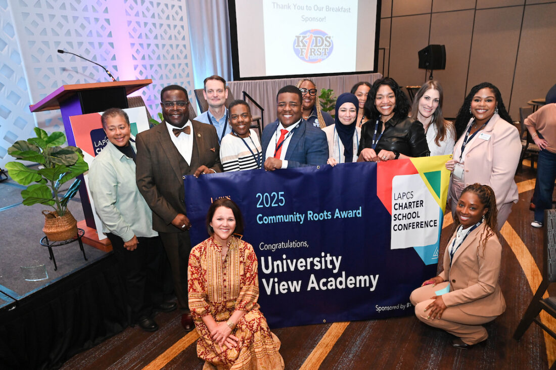 UVA and LAPCS staff members pose with Community Roots Award banner