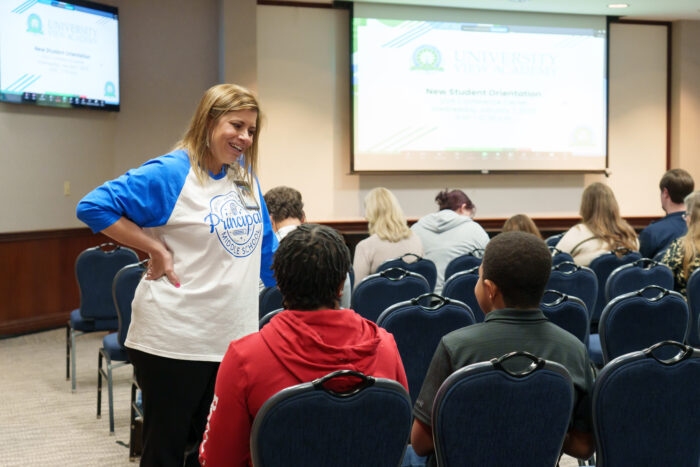 Middle school principal Brandy Garrett talks to a family.