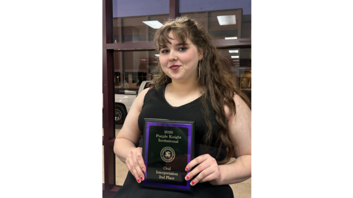Victoria Ballard holds her award plaque and poses for a picture.