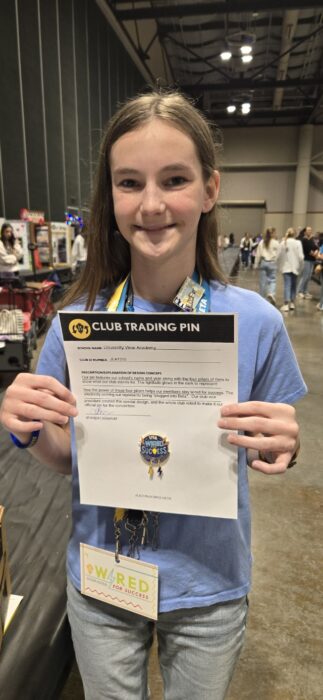 A Junior Beta Club member holds up a convention announcement