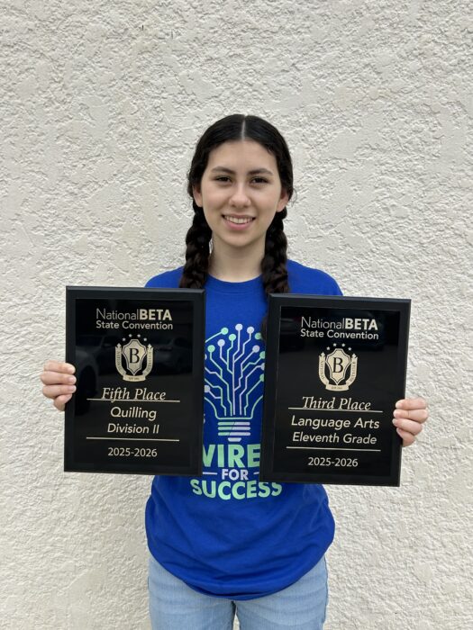 Anya Chaney-Martinez poses with her two award plaques