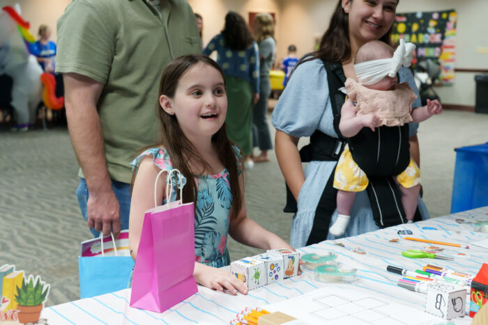 A student assembles a storytelling cube at Literacy Day