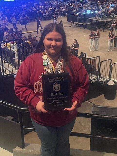 Kynlei Doucet poses for a picture with her award plaque