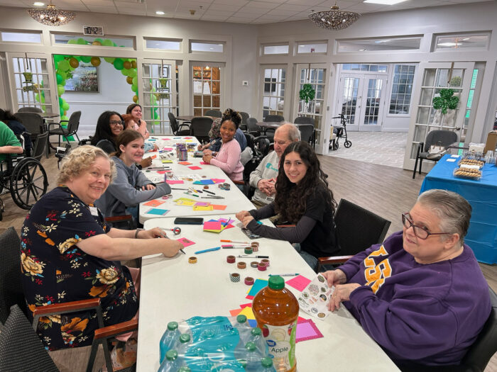 NHS students and residents of the senior living facility create cards together