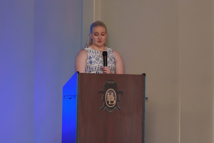 A student speaking at a podium