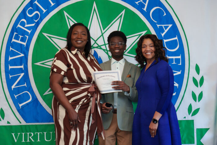 A student and his mother pose for a picture with Superintendent Timoll.
