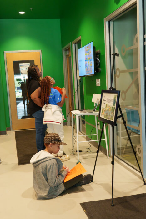 A family looks at student art on display