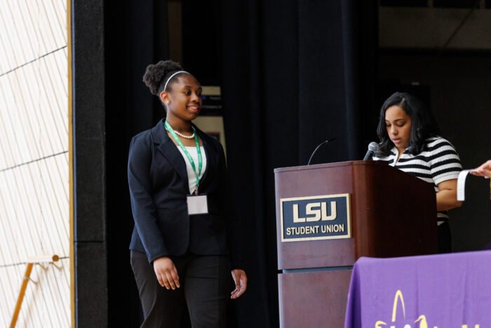 Oni Price walks to a podium at regional science fair.