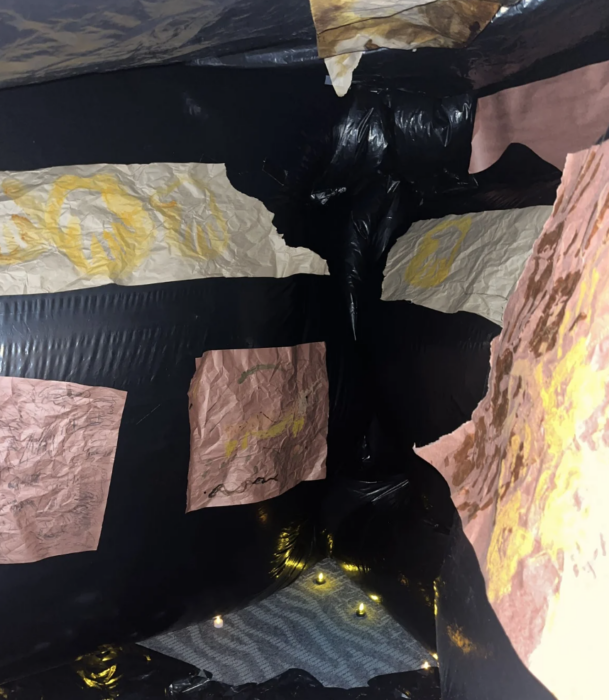 Inflatable cave walk-through experience with student art displayed