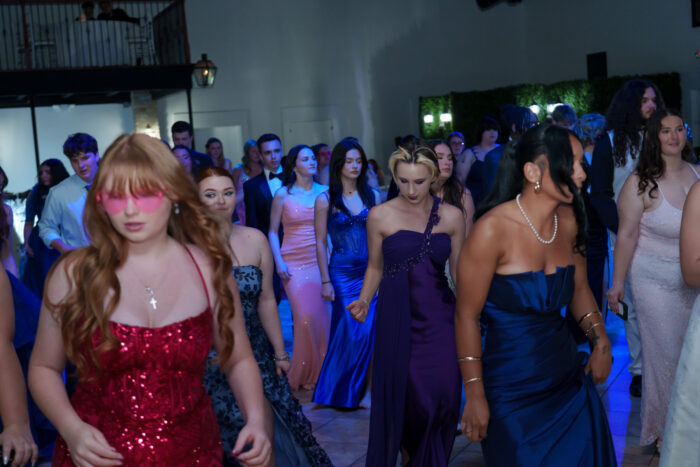 Students line dance at prom.