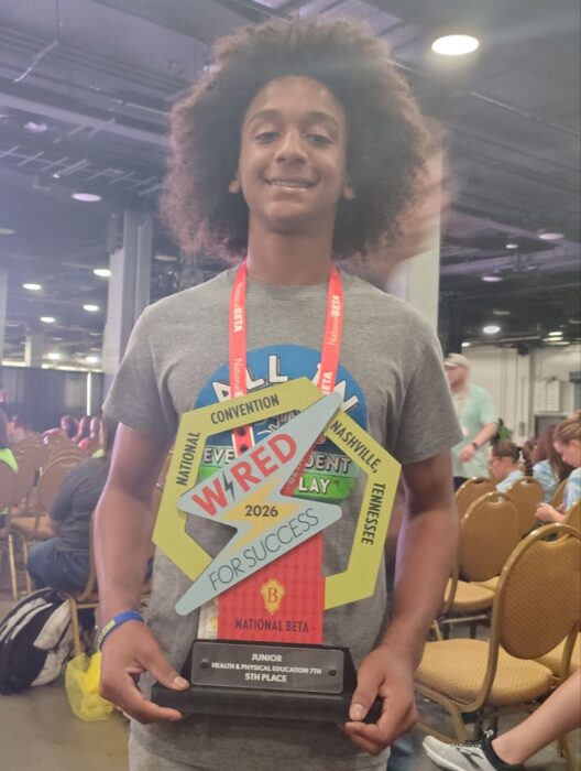 A student holds a colorful trophy at the 2026 National Beta Convention.