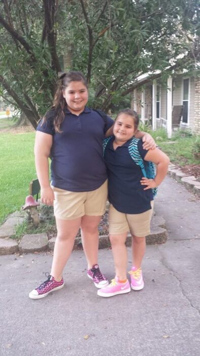 Barnett and another girl in elementary school uniforms.
