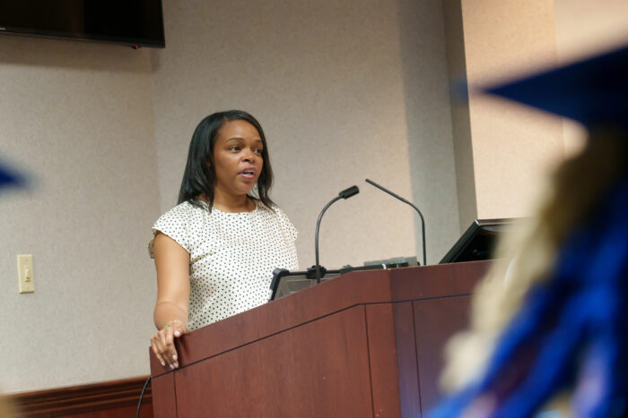 Principal Watson speaks at a podium.