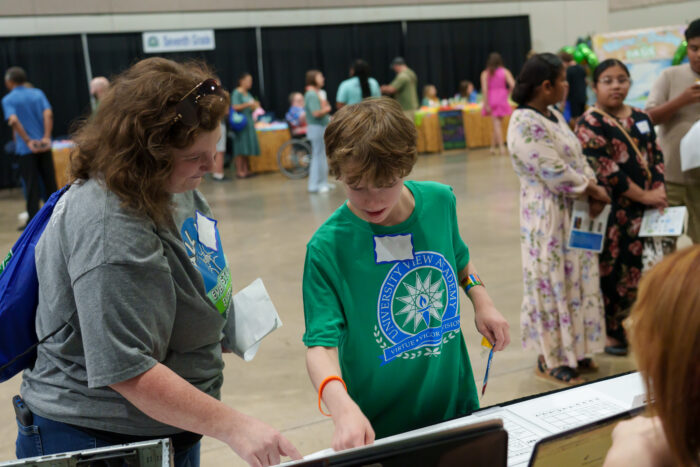 A student explores a table at open house.