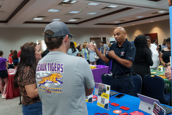 A recruiter talks to a family.