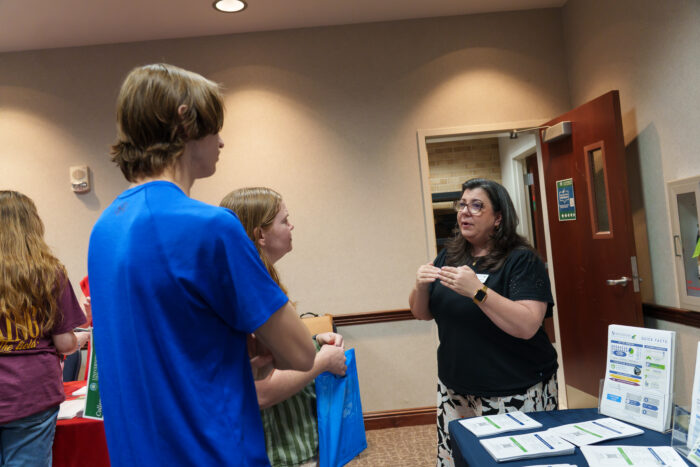 A recruiter talks to a family.